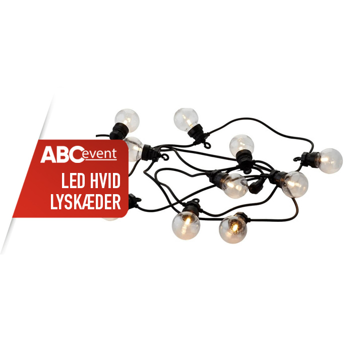 Eight shirts arranged on table in black, olive, grey, blue, white, red, mustard, and green.