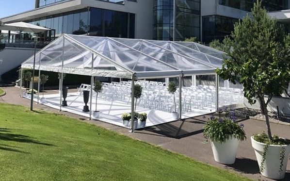 Eight shirts arranged on table in black, olive, grey, blue, white, red, mustard, and green.