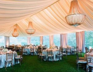 Eight shirts arranged on table in black, olive, grey, blue, white, red, mustard, and green.