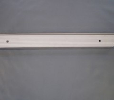 Eight shirts arranged on table in black, olive, grey, blue, white, red, mustard, and green.