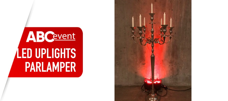 Eight shirts arranged on table in black, olive, grey, blue, white, red, mustard, and green.