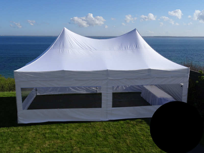 Eight shirts arranged on table in black, olive, grey, blue, white, red, mustard, and green.