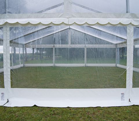 Eight shirts arranged on table in black, olive, grey, blue, white, red, mustard, and green.