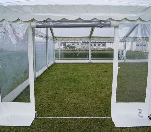 Eight shirts arranged on table in black, olive, grey, blue, white, red, mustard, and green.